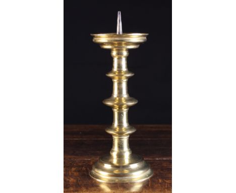 A Large 16th Century Nuremberg Pricket Stick. The spike on a dished drip pan above a triple blade knopped cylindrical stem an