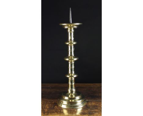 A Large 16th Century Bronze Pricket Stick. The iron spike in a dished drip pan above a cylindrical fillet knopped stem and ci