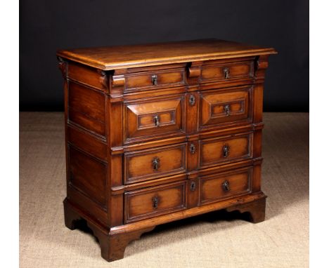 A Fine Late 17th/Early 18th Century Fruitwood Cushion Front Chest of Drawers. The four long moulded drawers hung of side runn