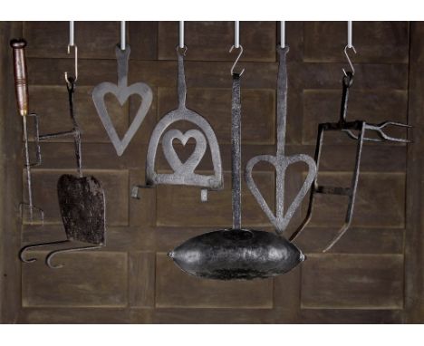 A Collection of 18th and 19th Century Fireside Implements to include; a fire-bar toaster, a fire-bar rack, a fire-bar heart s