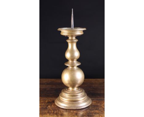 A Large 17th Century Bronze Pricket Stick, having an iron spike in drip pan above a bold baluster, fillet & ball knopped stem