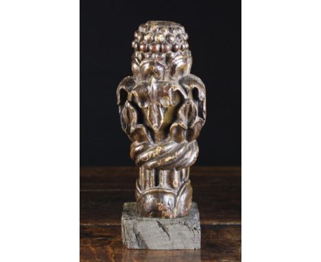 A 15th Century Carved & Painted Finial in the form of a clump of seeding foliage tied in a band of wrythen reeds, 8¼ ins (21 