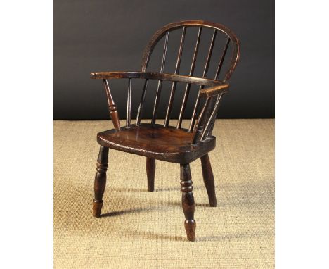 A Small 19th Century Child's Stick-back Windsor Armchair. The ash back hoop having five spindles piercing through the arm bow