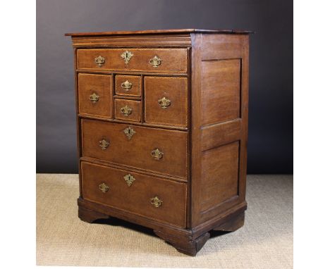 A Small 18th Century Oak Chest of Drawers with an unusual configuration of drawers, all edged in chequered feather banding an