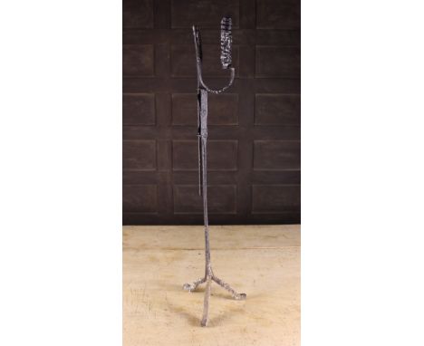 An Early 18th Century Wrought Iron Standard Rushnip / Candleholder. The sprung height adjustable light on central stem with t