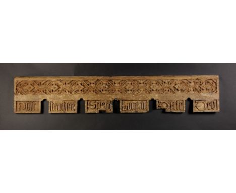An English Gothic Oak Rail Circa 1480. The crenulated base carved in relief with Latin text translating to 'Out of Darkness c