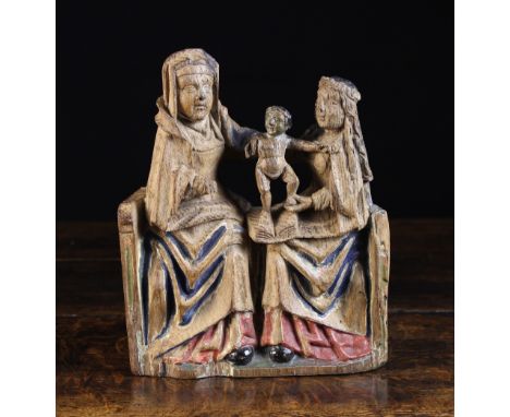 A 15th Century Oak Carving of St Anne,Virgin & Child with traces of polychrome. St Anne and Mary depicted sat on a bench with