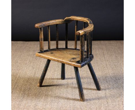 A Small 19th Century Child's Ash & Elm Stick-back Country Armchair with traces of residual paint-work. The three part arm bow