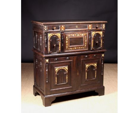 An Early 18th Century Inlaid Oak Chest on Chest decorated with panels of engraved bone and mother-of-pearl on fine scrolling 