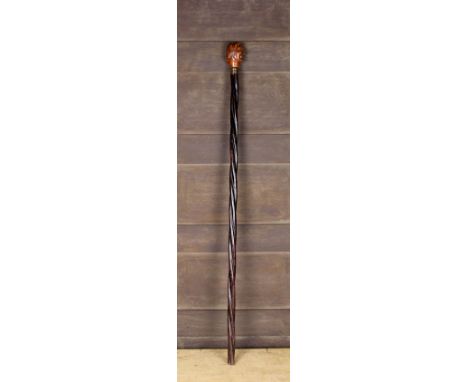 An Unusual Antique Walking Stick with a boxwood handle carved in the form the double-faced head of Janus above a metal ferrul
