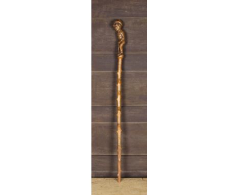 A 19th Century Applewood Walking Stick carved with disheveled figure of a Sweep dressed in a bowler hat & patched suit carryi