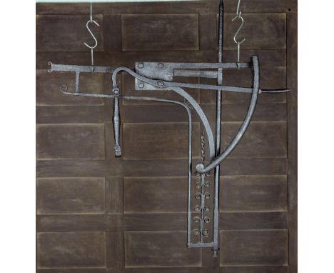 An 18th Century Wrought Iron Chimney Crane with three movements. The ratcheted swing-out pot hook on a scrollwork bracket, 41