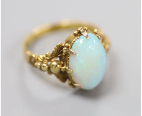 A 19th century yellow metal and oval white opal set dress ring, size M, gross 4.1 grams.CONDITION: One claw missing. Numerous