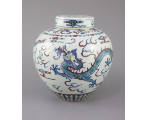 A Chinese doucai 'dragon' jar and cover, Qianlong seal mark, late 19th/early 20th century, the ovoid body painted with two sc