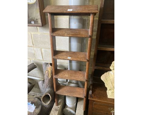 A four tread oak ladder, width 42cm, height 130cm