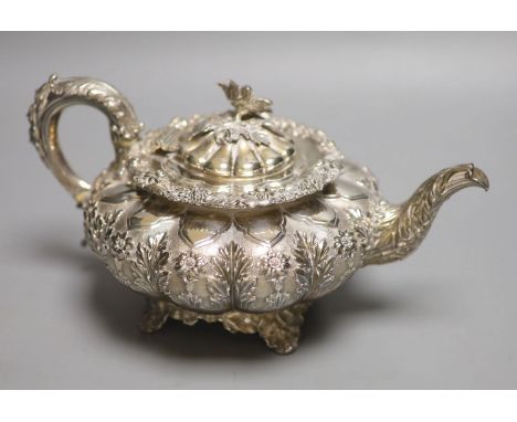 A George IV silver squat melon shaped teapot, embossed with flowers, The Barnards, London, 1829, gross 28oz.CONDITION: Lid a 