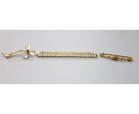 A yellow metal, moonstone and ruby set flower brooch, 38mm, gross 3 grams, a yellow metal and split pearl bar brooch, 72mm, g