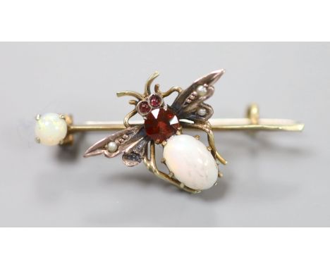 A Victorian yellow and white metal, white opal, garnet and seed pearl set bug brooch, 37mm, gross 2.7 grams.CONDITION: There 