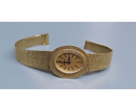 A lady's 9ct gold Bueche Girod manual wind wrist watch, on a textured 9ct gold bracelet, 15.7cm, gross 23.5 grams.CONDITION: 