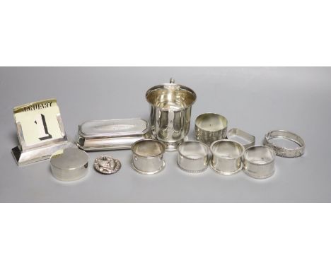 Small silver including a 1930's christening mug, a silver trinket box, five silver napkin rings, a silver mounted desk calend