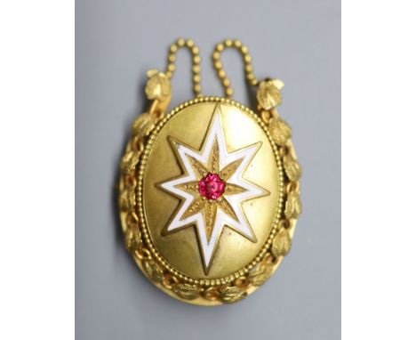 A Victorian gilt metal, white enamel and red paste set oval mourning brooch, with chain swags, 55mm