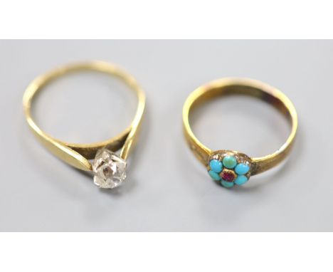 An 18ct and cushion cut solitaire diamond ring, size R, gross 2.7 grams and a late Victorian 18ct, ruby and turquoise cluster