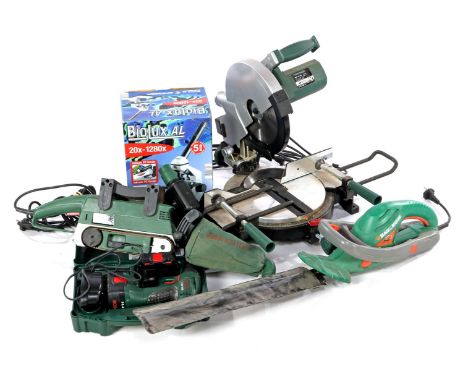 Bosch cordless screwdriver, Parkside miter saw, Parkside sander, Black and Decker hedge trimmer and Biolux AL microscope