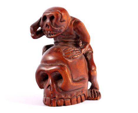 Boxwood netsuke of skeleton on skull, Japan, 5.5 cm high