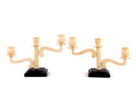 2 Art Deco ivory 3-light table candlesticks on a wooden base, Europe ca.1925, 28 cm wide, together 998 grams. With certificat