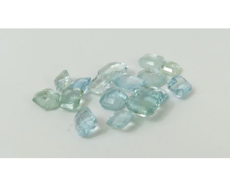 A collection of loose step cut aquamarine stones, various sizes; and a heart shaped moonstone