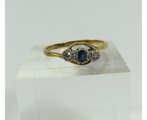 An early 20th century sapphire and diamond three stone diamond twist ring, marked '18ct plat', finger size Q, 2.51g gross, in