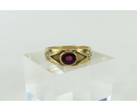 A ruby and diamond dress ring, the oval ruby set lengthways in a rub-over setting, with raised V shapes to the shoulders and 