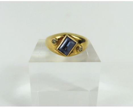 A contemporary design tanzanite and diamond dress ring, the step cut tanzanite, approximately 1.44ct, set at an angle into th
