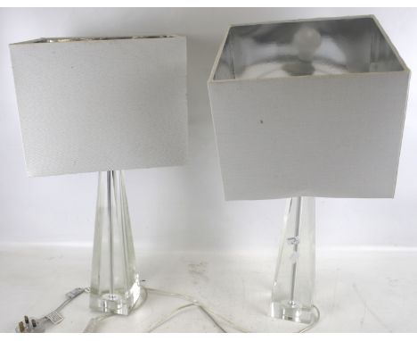 A pair of contemporary clear glass table lamp bases. With square shades. H56cm