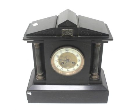 A 20th century black slate striking mantle clock. With architectural features, the enamel dial with Arabic numerals. H33cm