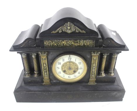 A 20th century slate mantle clock. The enamel and gilt dial with Arabic numerals, in an architectural case with brass details
