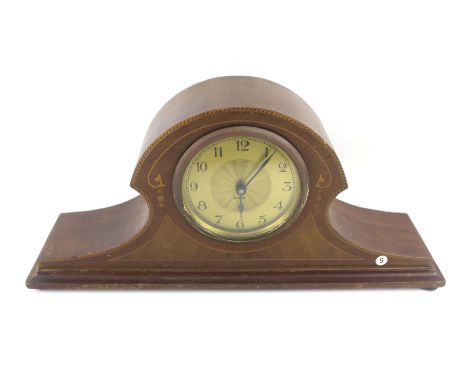 An Edwardian mantle clock. The brass dial with Arabic numerals, 8 day movement, within a mahogany case with string inlaid det