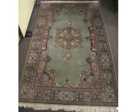 A Persian style wool rug. With light green ground and decorative border. 240cm x 150cm