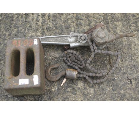 A vintage chain winch and a 56lb metal weight.