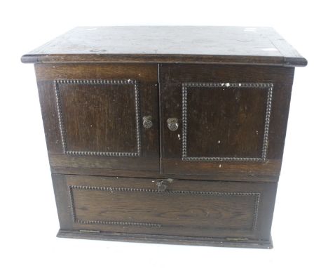 An vintage oak table top cupboard. With lid, two doors and a drop down door below. L49cm x D33cm x H41cm