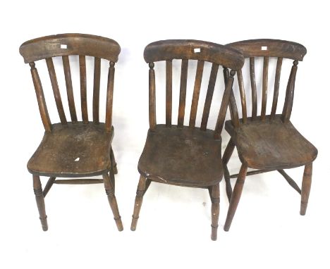 A set of three vintage stained oak kitchen chairs. Raised on turned supports united by stretchers, H86cm
