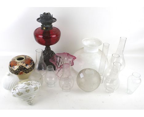 An assortment of Victorian and later oil lamp components. Including bases, reservoirs, shades, funnels, etc.