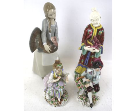 Four ceramic figures. Comprising a Lladro figure of a girl holding a turkey, an oriental figure AF and a pair of German Sitze