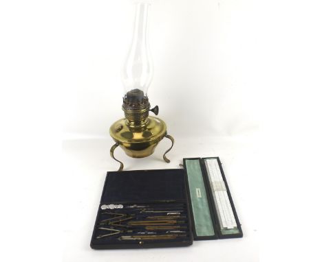 An assortment of collectables. Including a BRL slide rule, an engineer's drawing set and a brass oil lamp. Max. H23cm