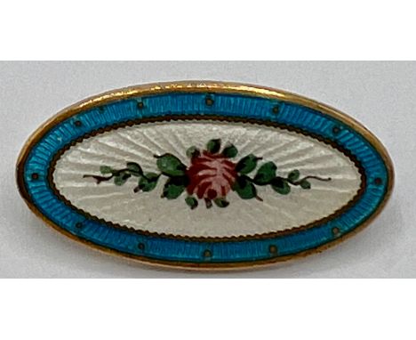 An Edwardian oval enamel brooch depicting a pink rose on a white background within a turquoise border. Approx. 3 x 1.5cm. 