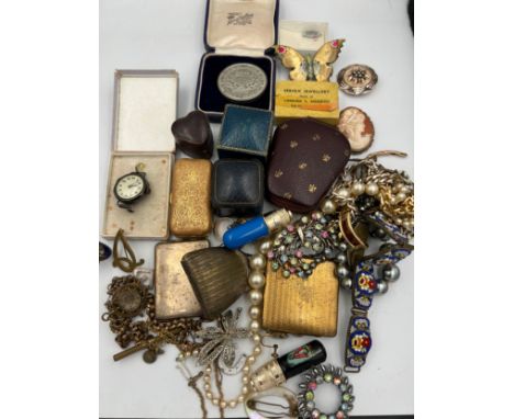 A quantity of vintage costume jewellery, ring boxes, purse, match book cover, silver mounted cameo brooch, continental silver