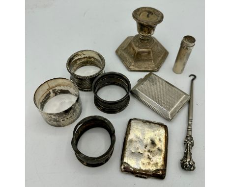 A quantity of hallmarked silver to include 4 napkin rings, various makes and dates, two vesta cases, one machine turned, weig