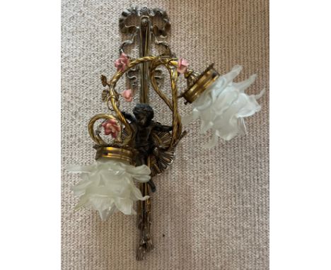 A good quality decorative brass wall light with cherub, ceramic flowers and glass shades. 54cm h. 