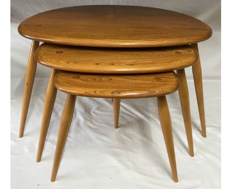 An Ercol Golden Dawn nest of three Pebble side tables largest 40.5h x 65w x 45cm d. 