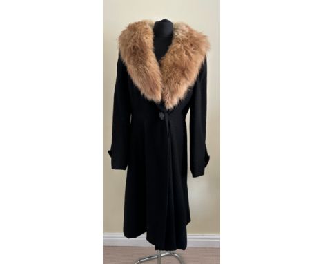 A ladies black coat with a fur collar with 'Marlbeck Model' label and button details to the cuff approx. 112cm from shoulder 